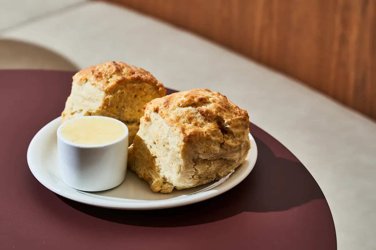 a piece of cake on a plate next to a cup of coffee
